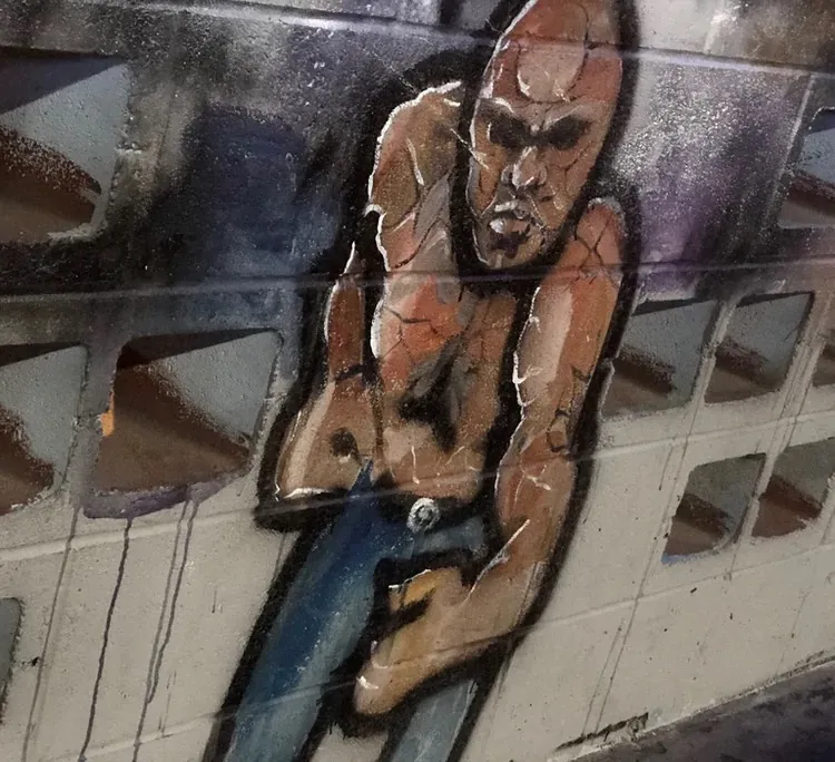 The Cave Bar: Strongman, mural by JustBee