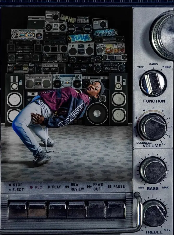 JustBee in a deep backbend, framed inside a boombox