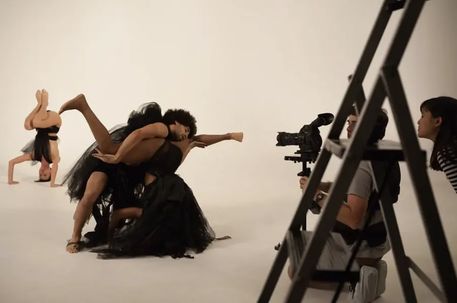 JustBee and her partner in a tangled lift as the film crew shoots