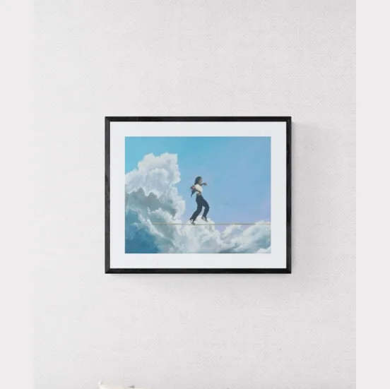 Not Like Us print: a figure walking a tightrope through clouds, framed on a wall
