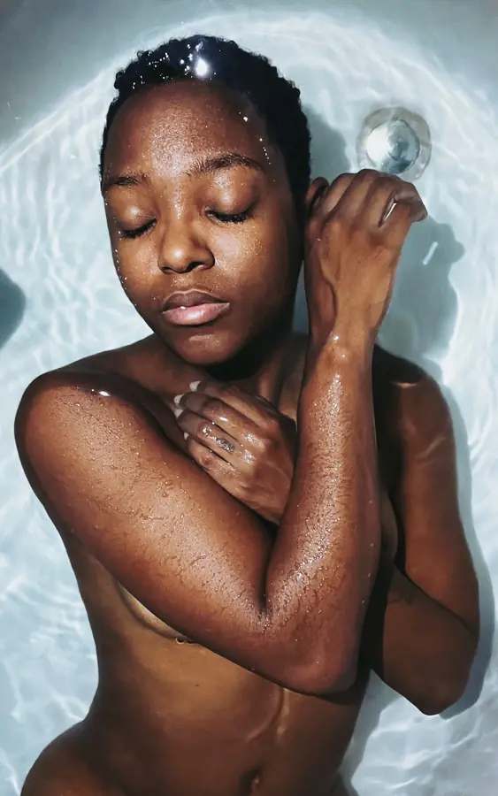 JustBee resting in bath water with her eyes closed