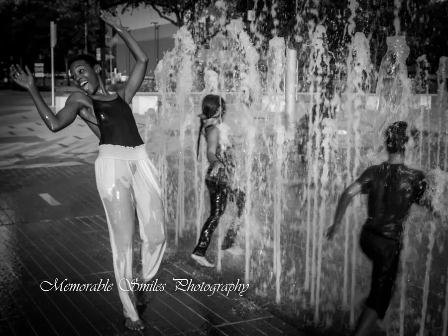 JustBee dancing in a fountain, black and white
