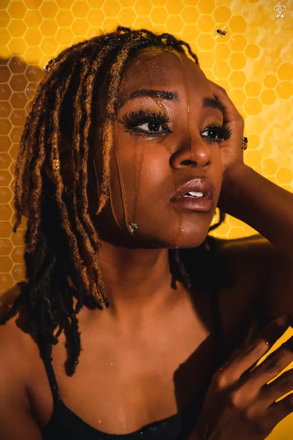 JustBee looking up with honey running down her face